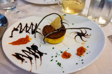 Cuisine of EmiliaRomagna region, baked Italian parmesan sformato or flan made with grated Parmigiano Reggiano cheese from Parma and served with balsamic vinegar of Modena