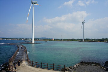 Obraz premium a bridge on the sea and wind power plants