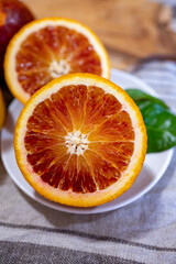 Sicilian sweet juicy yellow and red blood oranges with green leaves close up