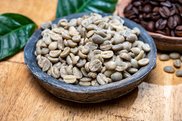 Green un-roasted and brown roasted coffee beans from Africa coffee producing region, cultivating in Ethiopia, Ivory Coast, Uganda, Kenya, Rwanda and Tanzania