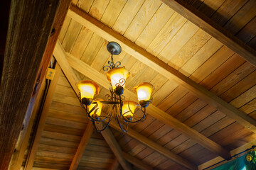 Close up shot of an antique lamp hanging on the ceiling