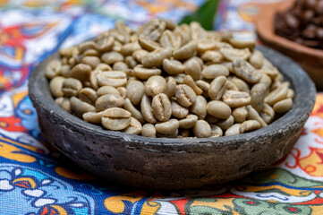 Green and roasted coffee beans from South America coffee producing region, from Colombia and Brazil with  mountain ranges and climate ideal for coffee growing