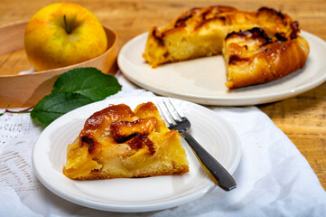 Baked apple cake with almond frangipani custard close up