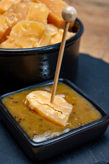 Cheese tasting, small pieces of old Dutch hard cheese and bowl with homemade dill-mustard sauce