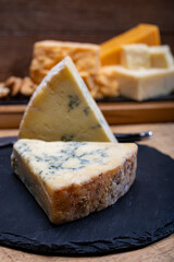 British cheeses collection, blue Stilton, Scottish coloured and English matured cheddar cheeses