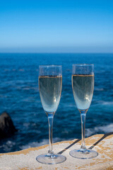 New year celebration with two glasses of champagne or Spanish cava sparkling wine and view on blue Atlantic ocean, Canary islands, winter tourists destination
