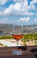 Wine industry of Cyprus island, tasting of rose dry wine on winery with view on vineyards and south slopes of Troodos mountain range.