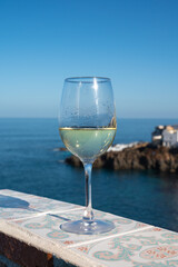 Drinking of white wine with view on blue Atlantic ocean on Tenerife, Canary islands, Spain