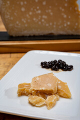 Tasting of 72 months very old Italian parmigiano-reggiano parmesan cheese from Parma   with black pearls of balsamic vinegar DOP from Modena.