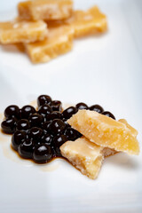 Tasting of 72 months very old Italian parmigiano-reggiano parmesan cheese from Parma   with black pearls of balsamic vinegar DOP from Modena.