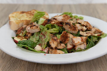 Creative recipe of apple pecan chicken salad served in a generous bowl with garlic toast for a delicious meal to eat