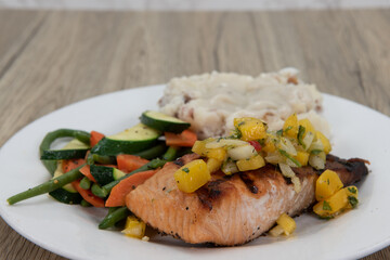 Rich protein in this hearty grilled salmon fillet served with mashed potatoes and mixed vegetables