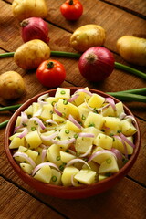 Organic boiled potato salad with fresh herbs and cheese. 
