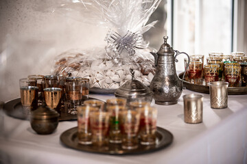 Traditional Morrocan tea pot and tea glasses, with orential pastries, for a wedding