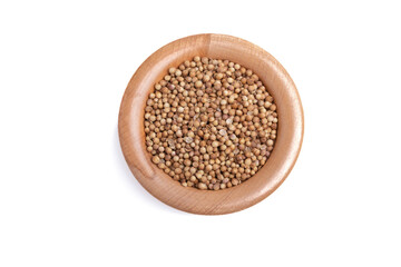 coriander seeds in a wooden cup on a white background