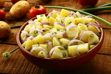 Boiled potato slices  with exotic fresh herbs- healthy  vegan diet meal.