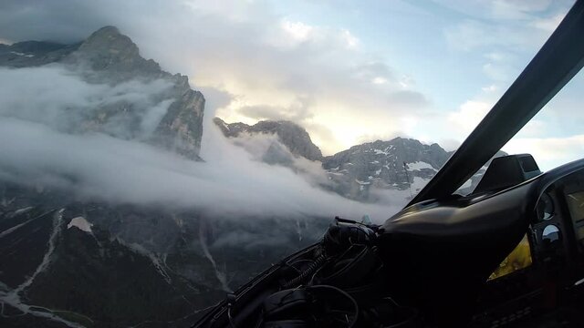 First-person perspective from a wingsuit flyer soaring by mountains