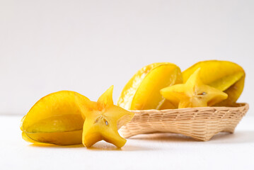 Ripe star fruit or Carambola in bamboo basket on white background