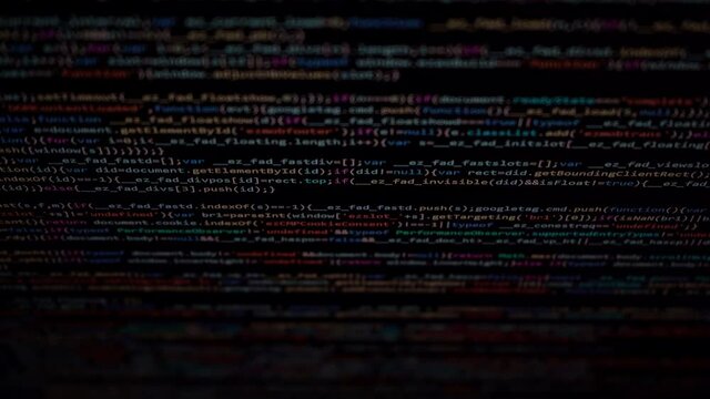 Computer algorithm scrolling on a dark monitor showing coding lines