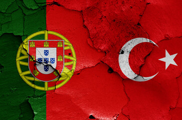 flags of Portugal and Turkey painted on cracked wall