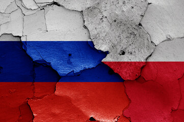 flags of Russia and Poland painted on cracked wall