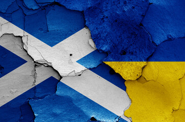 flags of Scotland and Ukraine painted on cracked wall
