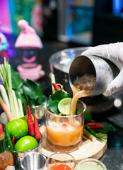 Cocktail Tom Yum drink, Made with vodka mixed with Thai herbs, lime, lemongrass, chili, galangal, kaffir lime leaves and cane sugar, delicious, fragrant, Thai style