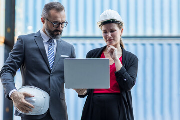 Businessman and Secretary work at Container cargo site check up goods in container. Manager and...