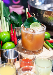 Cocktail Tom Yum drink, Made with vodka mixed with Thai herbs, lime, lemongrass, chili, galangal, kaffir lime leaves and cane sugar, delicious, fragrant, Thai style