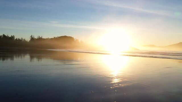 Sunrise Reflections On A Beach With Waves