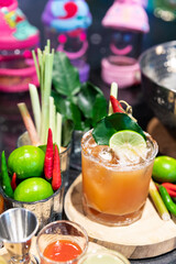 Cocktail Tom Yum drink, Made with vodka mixed with Thai herbs, lime, lemongrass, chili, galangal, kaffir lime leaves and cane sugar, delicious, fragrant, Thai style