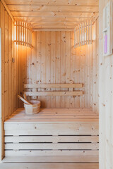 Fototapeta na wymiar Small home wooden sauna, spa room. Relax in a hot sauna.