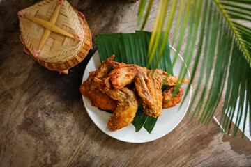 fried chicken Traditional Asian or Northeastern Thai food half grilled chicken wing.
