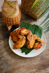 fried chicken Traditional Asian or Northeastern Thai food half grilled chicken wing.