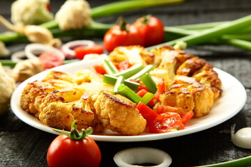 Homemade grilled cauliflower  and organic  vegetables. tomatoes, green beans onions, healthy vegan diet meal.