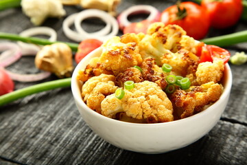 Homemade delicious vegetarian curry- roasted cauliflower vegetable with spices and herbs.