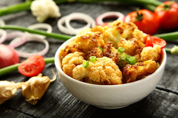 Delicious cauliflower roast curry served in ceramic bowl, 