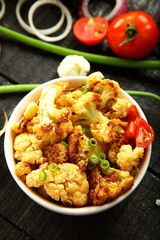 Healthy vegetarian curry meal- cauliflower roast with exotic Indian spices and herbs.