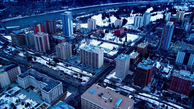 Edmonton 109 St NW and 99 Ave flyover winter snow covered Government and Residential buildings overlooking the downtown city headed South West towards Victoria Valley Park and curvy river university