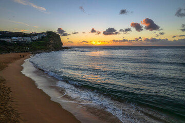 Breezy aerial sunrise seascape with clouds
