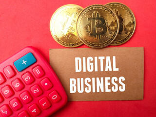 Top view golden bitcoin and calculator with text DIGITAL BUSINESS on blue background.
