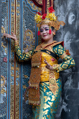 Balinese dancer woman in gold costume, Temple Bali Indonesia