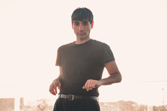 Young entrepreneur investor looking straight to camera during the sunset copy space, investing, crypto financial freedom concept. Happy about his new scholarship bur serious and worry