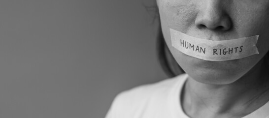 woman with mouth sealed in adhesive tape with Human rights message. Free of speech, freedom of...