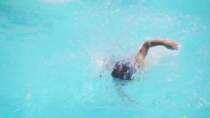 Little girl wearing goggles swim in the swimming pool and do freestyle. Kid enjoy happy fun in water park, for learn and training swim, relax exercise on summer school