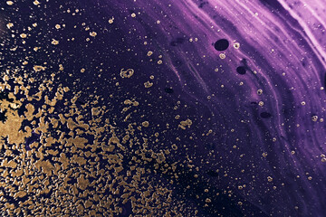 Fluid Art. Metallic gold particles and black purple waves. Marble effect background or texture