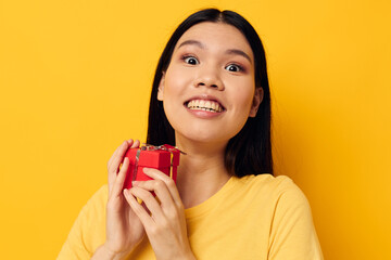 Portrait Asian beautiful young woman in a yellow t-shirt holiday gift emotions studio model unaltered