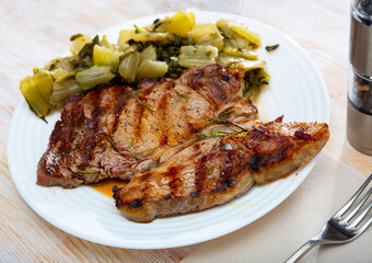 Barbecue veal steak served with marinated chopped chard leaves