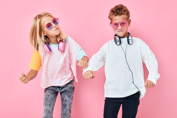 funny little boy and girl wearing headphones posing Childhood lifestyle concept