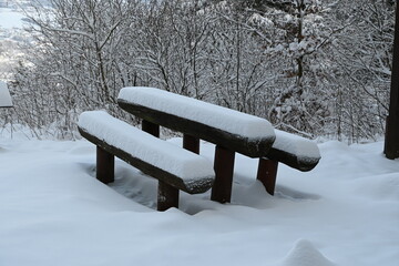 Snow on a picnic bench with table in winter in the Rhön, Kreuzberg near Bischofsheim, Bavaria,...